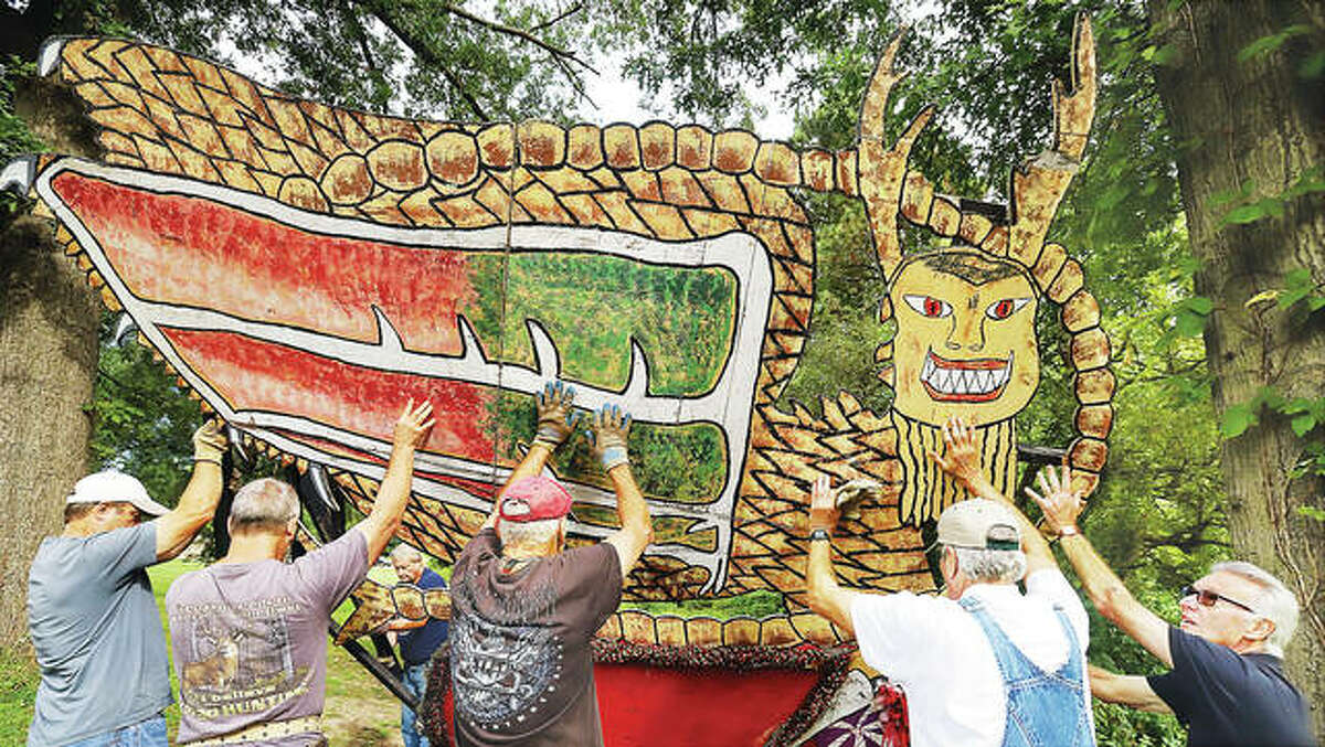 Members of the Grandpa Gang push the Piasa Bird into place Wednesday in Alton’s Rock Spring Park as work gets underway for the annual Christmas Wonderland light display planned Nov. 26 to Dec. 27. Work began this week with erecting the “flats” or static displays in the park, a job that requires several people at the same time. Additional photos can be seen online at thetelegraph.com.