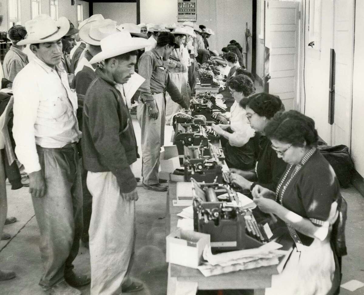Clerks complete short-term labor contracts and create identification cards for workers in the bracero program, which ran from 1942 to 1964.