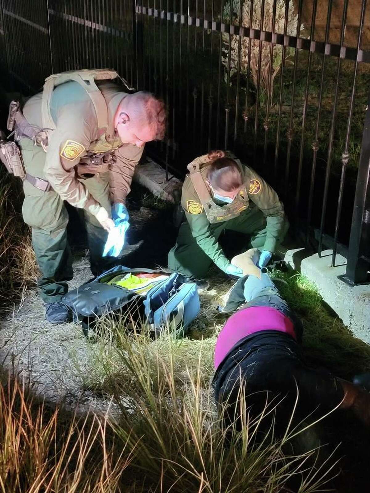 U.S. Border Patrol agents are seen rendering aid to a migrant woman who had an injury to her ankle. Authorities encountered her after responding to an injured person report early Tuesday near the Sacred Heart Children’s Home on U.S. 83.