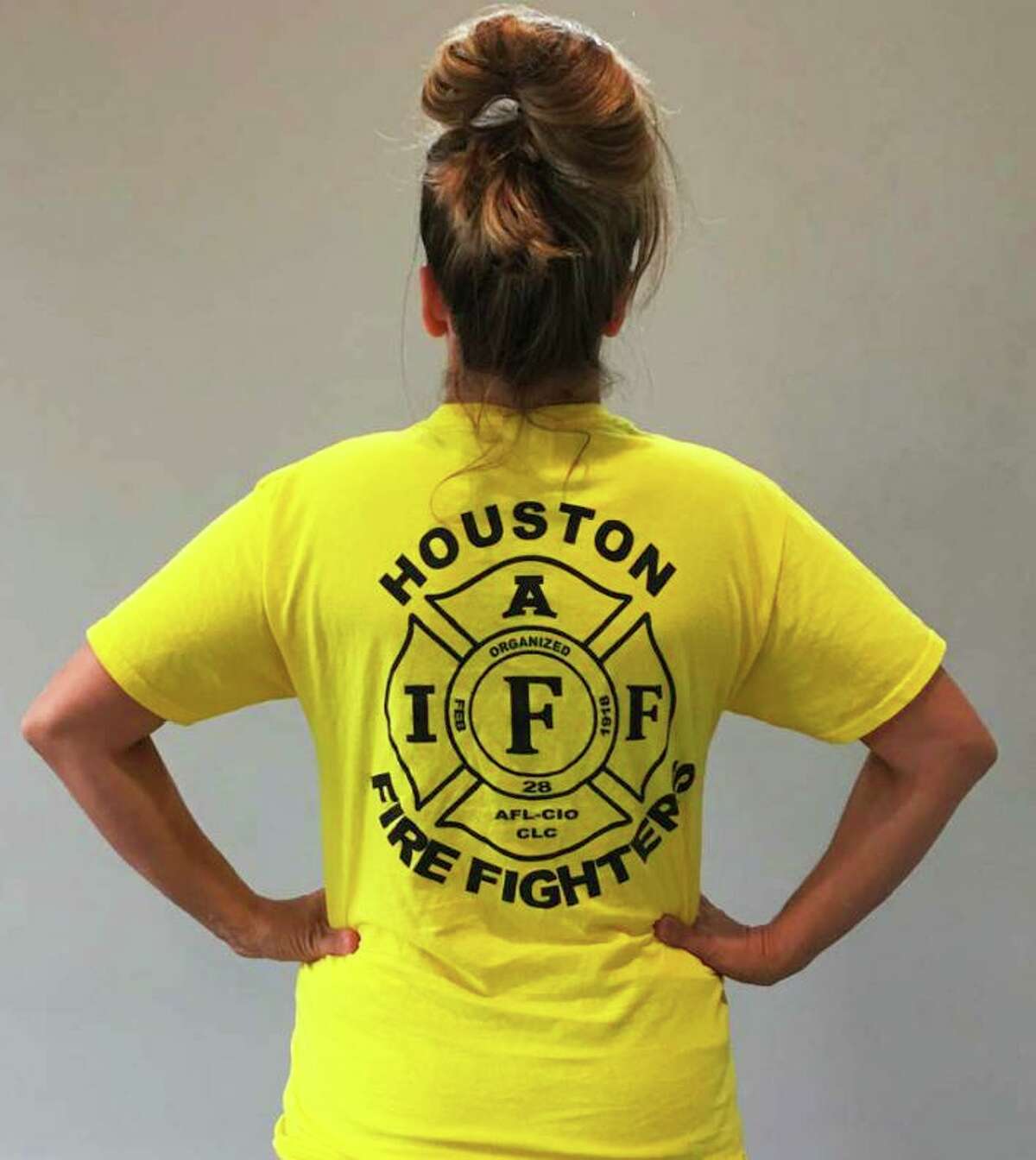 Jillian Ostrewich, who is married to a Houston firefighter, is pictured wearing the T-shirt she wore to a Harris County polling place for early voting in October 2018, when a pay parity measure for firefighters was on the ballot. According to court documents, election officials told her she could not cast her vote with the logo showing, so she turned her T-shirt inside out and was able to proceed.