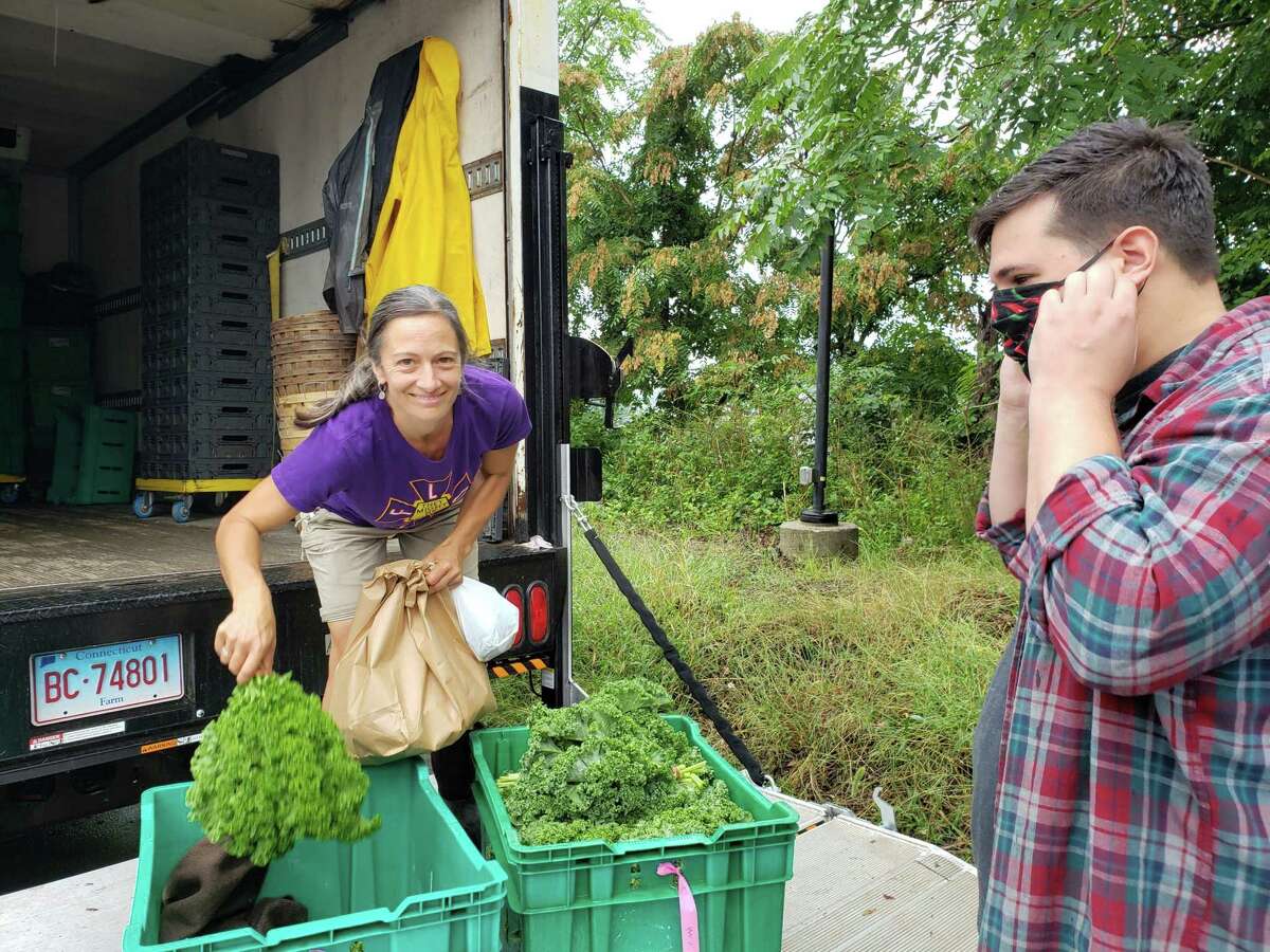 Chef Alec Demonico of Kawa Ni in Westport picking up produce from Rebecca Batchie of Fort Hill Farm.