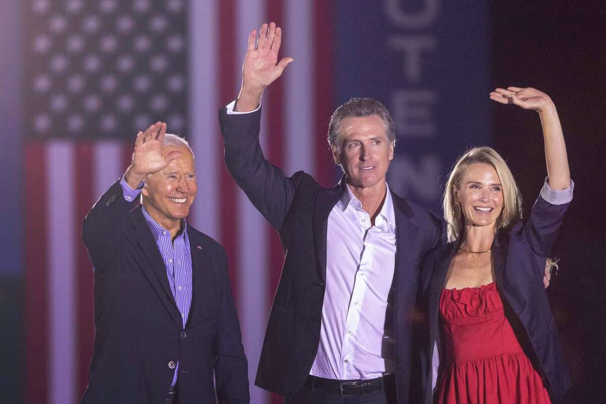 President Biden, California Gov. Gavin Newsom and Jennifer Siebel Newsom wave to the crowd as they campaign to keep the governor in office at Long Beach City College on the eve of the last day of the special election to recall the governor.