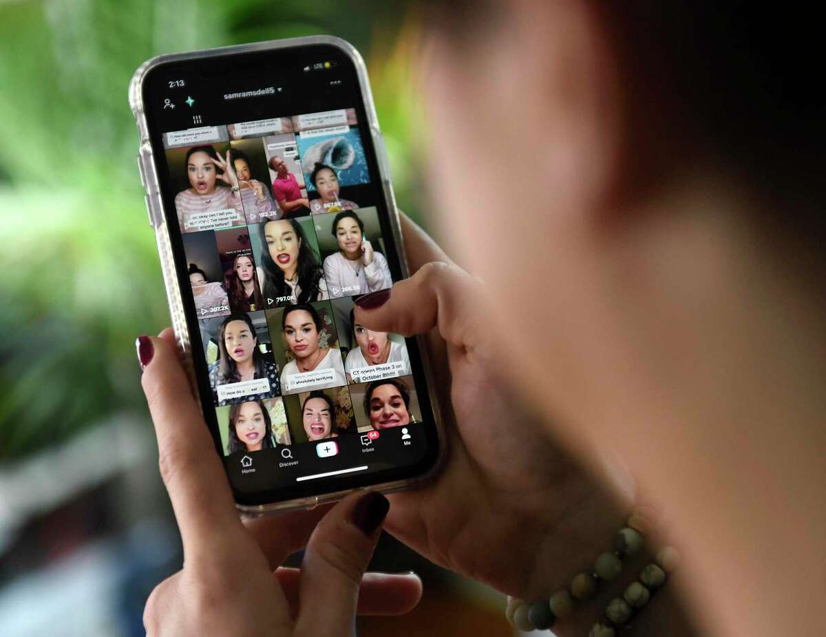 A TikTok star shows her TikTok feed on her phone at her home in Stamford, Conn. Tuesday, Oct. 27, 2020.