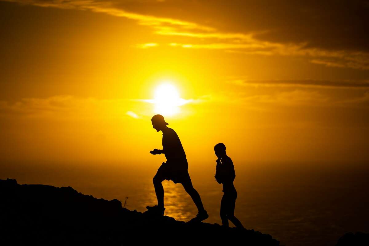 In this 2020 file photo, people walk the Makapuu Point Lighthouse Trail on the eastern shore of the island of Oahu on Oct. 19, 2020 in Honolulu, Hawaii.