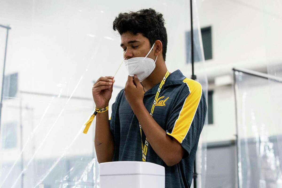 Yash Hande conducts his own COVID-19 test at a mass testing site set up in UC Berkeley’s Tang Center on August 23, 2021. Case rates and hospitalizations are down in the Bay Area.