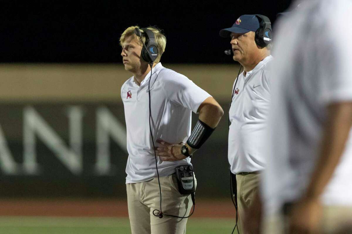 Atascocita head coach Craig Stump (right) stands on the sidelines next to his son Joshua Stump (left) during the second half of a high school football game Friday, Sep 6, 2019, in Humble, Texas.