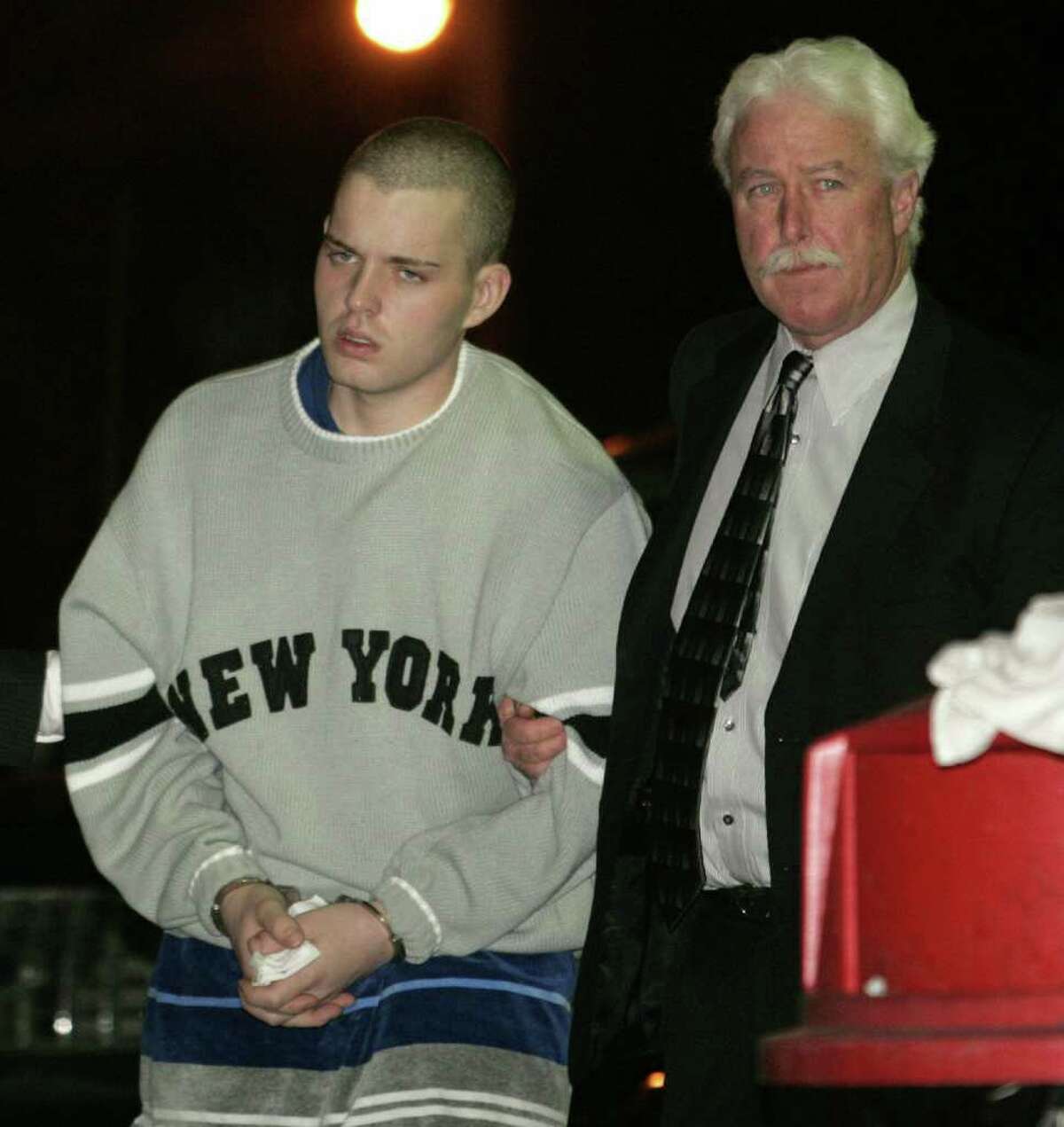 Christopher DiMeo, left, is escorted by a Nassau County homicide detective into police headquarters in Mineola, N.Y., Tuesday, Feb. 8, 2005. DiMeo, an ex-convict suspected in a string of jewel heists that left three people dead in two states, was charged Tuesday with murder. (AP Photo/Ed Betz)