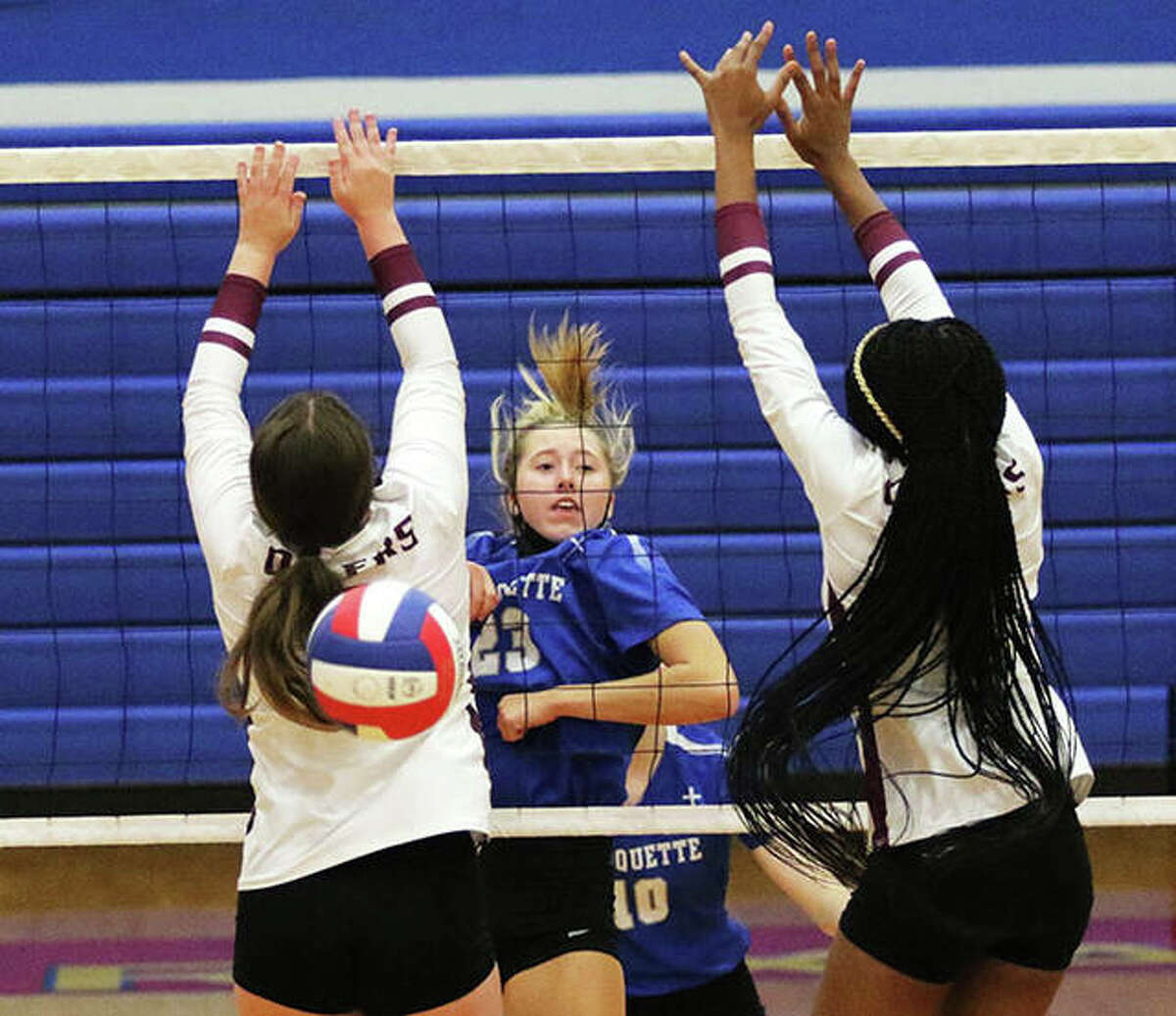 Marquette Catholic’s Kylie Murray (middle) watches her attack between two EA-WR blockers fall for a kill in an Aug. 23 match at the Roxana Tourney. On Wednesday, Murray had a career-high 10 kills in the Explorers’ win over Cahokia in Alton.