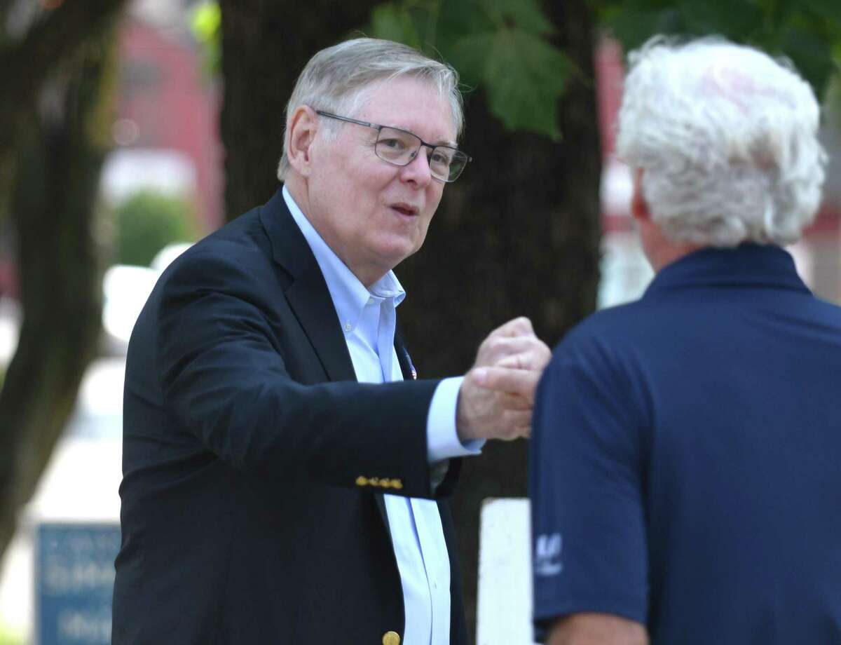 Stamford incumbent Mayor David Martin chats with a voter outside Dolan Middle School on Primary Election Day in Stamford, Conn. Tuesday, Sept. 14, 2021.