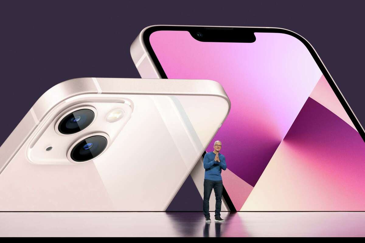 Apple CEO Tim Cook unveils the iPhone 13 last year. The expected iPhone 14 should get its day in the spotlight soon. But should you buy it?