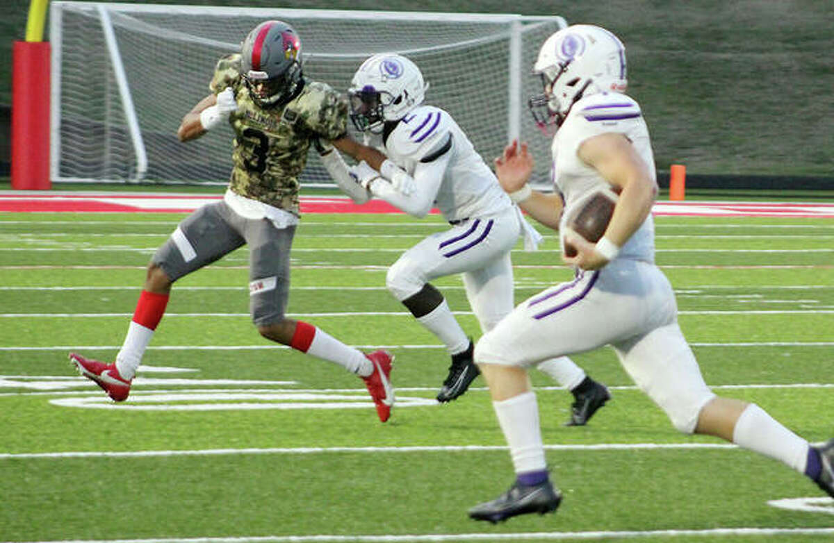 A Collinsville player tries to block Alton’s Julian Caffey (3) last Friday at Public School Stadium. The Redbirds will open Southwestern Conference play Friday at home against Belleville West.