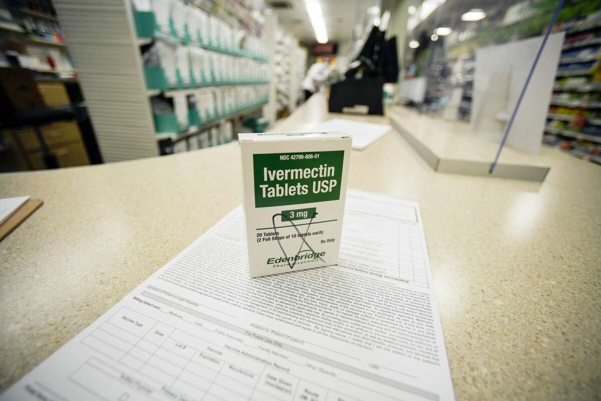 A box of ivermectin is shown in a pharmacy as pharmacists work in the background, Thursday, Sept. 9, 2021, in Georgia.