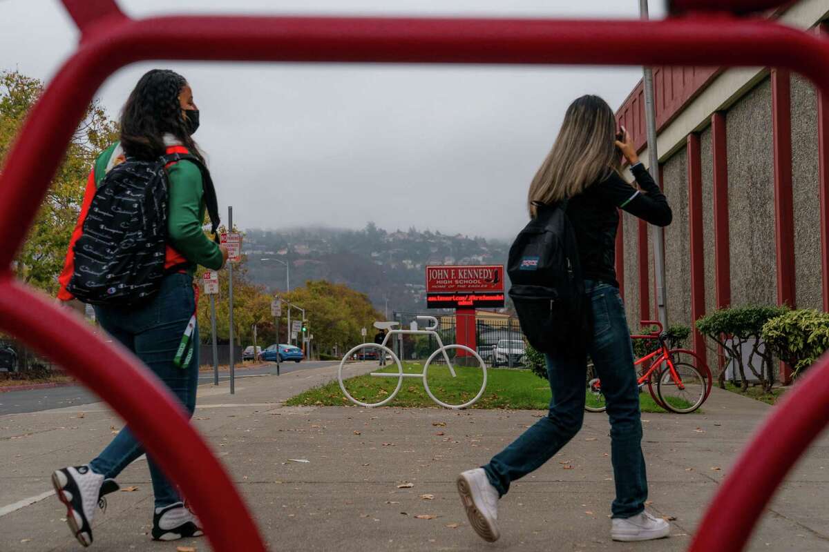 Students arrive at John F. Kennedy High School in Richmond on Tuesday. The Contra Costa County district that includes the school is considering mandating vaccines for eligible children.