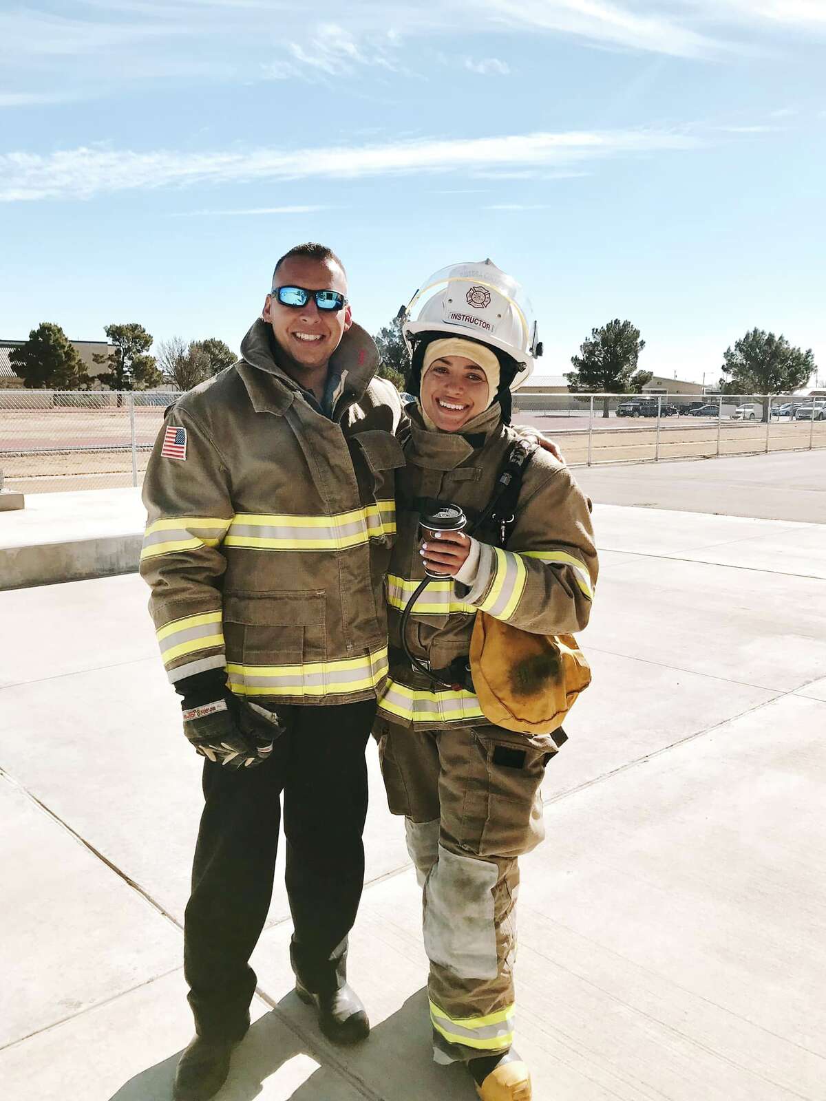 Clarke and her fiancé in firefighter gear.