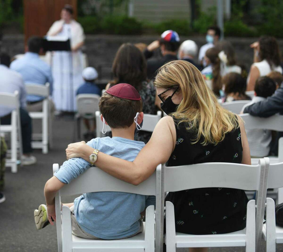 Karyn Schmeidler of Greenwich and her son, Micah, 8, attend the Yom Kippur Family Service at the Greenwich Reform Synagogue in Greenwich, Connecticut on Thursday, September 16, 2021. Worshipers celebrated Yom Kippur, the day of Jewish Atonement, with a variety of readings and songs.