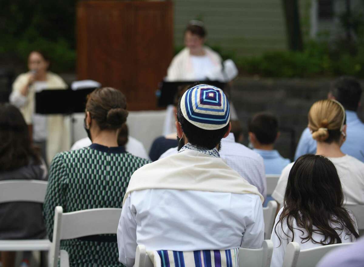 Worshipers attend the Yom Kippur family service at the Greenwich Reform Synagogue in Greenwich, Connecticut on Thursday, September 16, 2021. Worshipers celebrated Yom Kippur, the Jewish Day of Atonement, with a variety of readings and songs.
