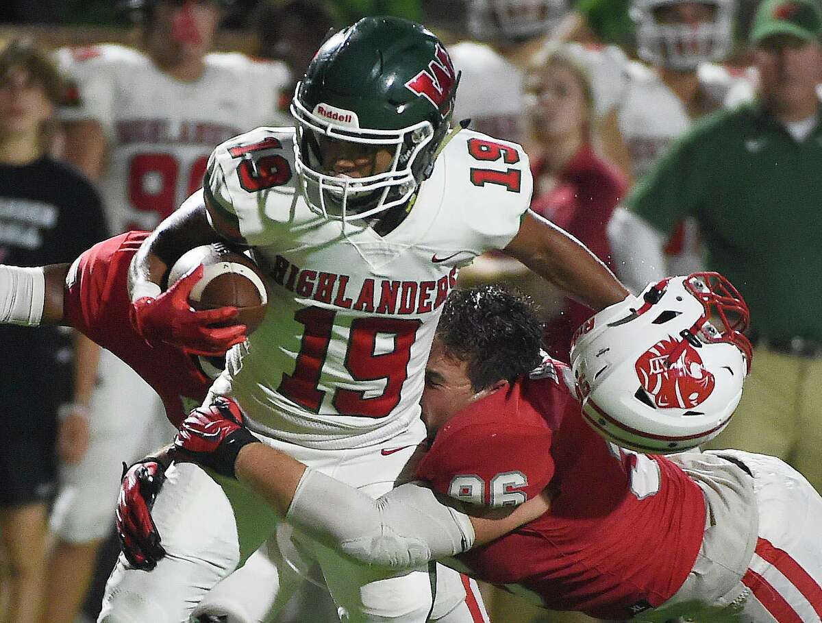 The Woodlands wide receiver Jason Williams (19) is tackled by Katy defensive lineman Dylan Bennett during the second half of a high school football game, Thursday, Sept. 16, 2020, in Katy.