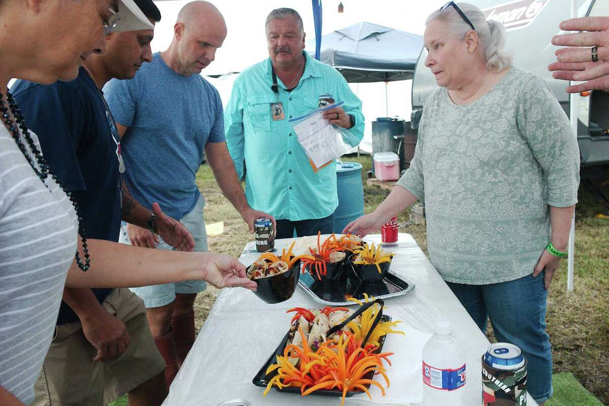 Judges, Kristina Otwell, Rasheed Rambaran, Mason Aman and Ed Ybarra prepare to sample fiesta shrimp tacos prepared by Beth and Joe Robinson of Keeping Southern Kookers.