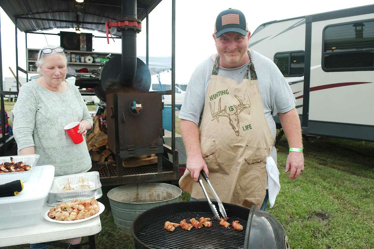 Beth Robinson watches as her Husband Joe of Keeping Southern Kookers prepares one of their signature dishes, fiesta shrimp tacos.