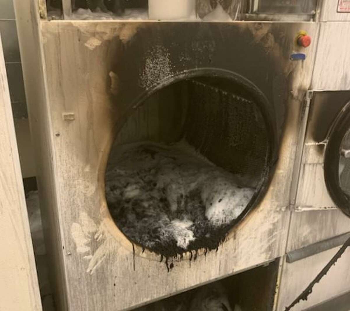 A dryer is seen after it started a fire that was put out by a sprinkler system at an LA Fitness in Spring.