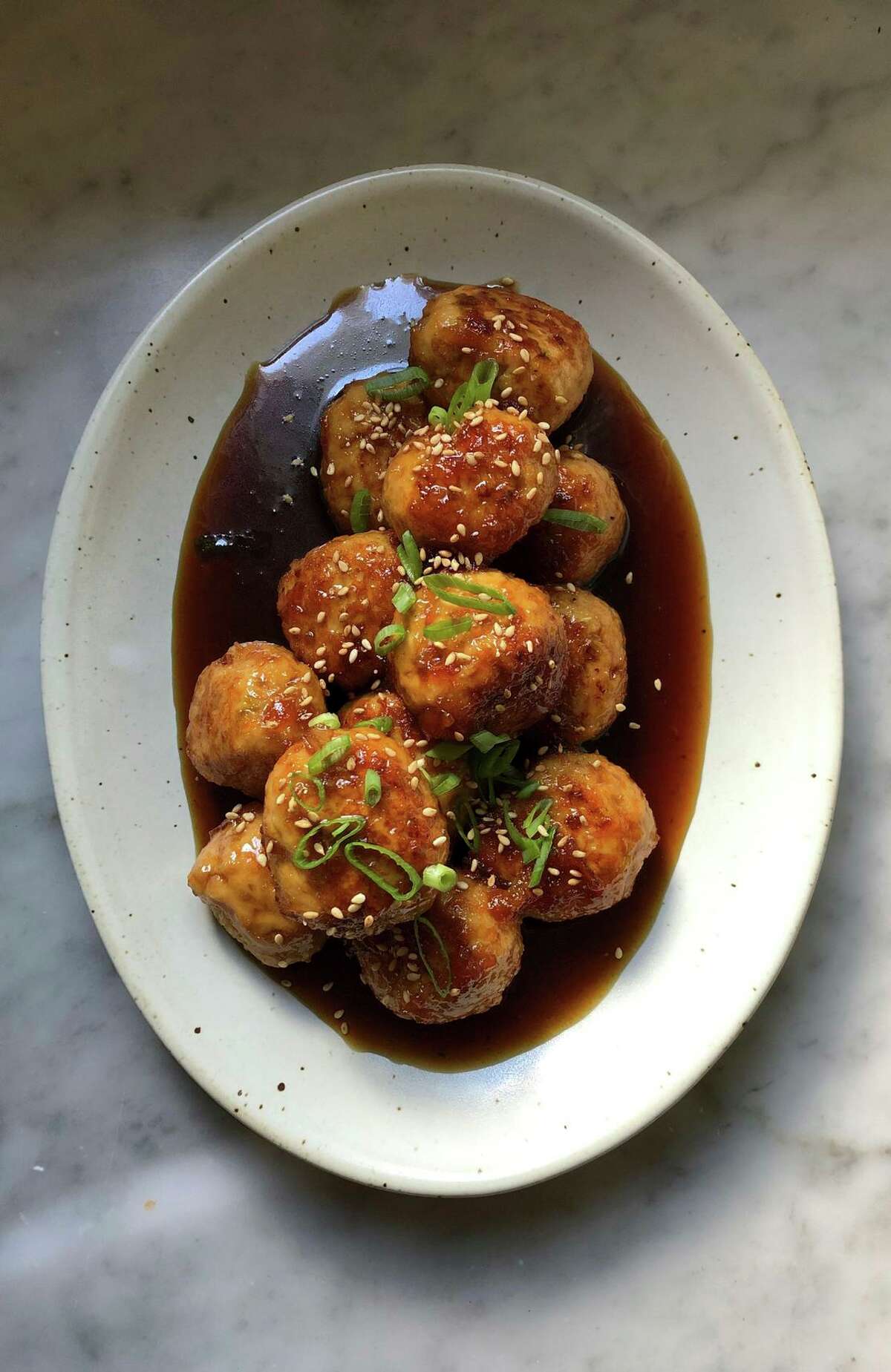 Chicken meatballs are bathed in a four-ingredient glaze that includes light-bodied soy sauce and orange marmalade.
