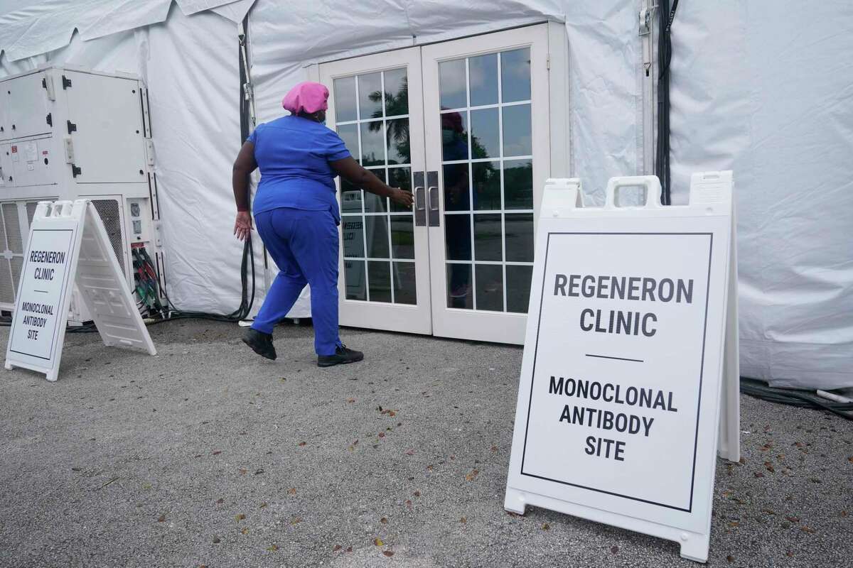 A nurse enters a monoclonal antibody site, Wednesday, Aug. 18, 2021, at C.B. Smith Park in Pembroke Pines, Fla. Similar sites are open around Texas offering monoclonal antibody treatment sold by Regeneron to people who have tested positive for COVID-19. (AP Photo/Marta Lavandier)