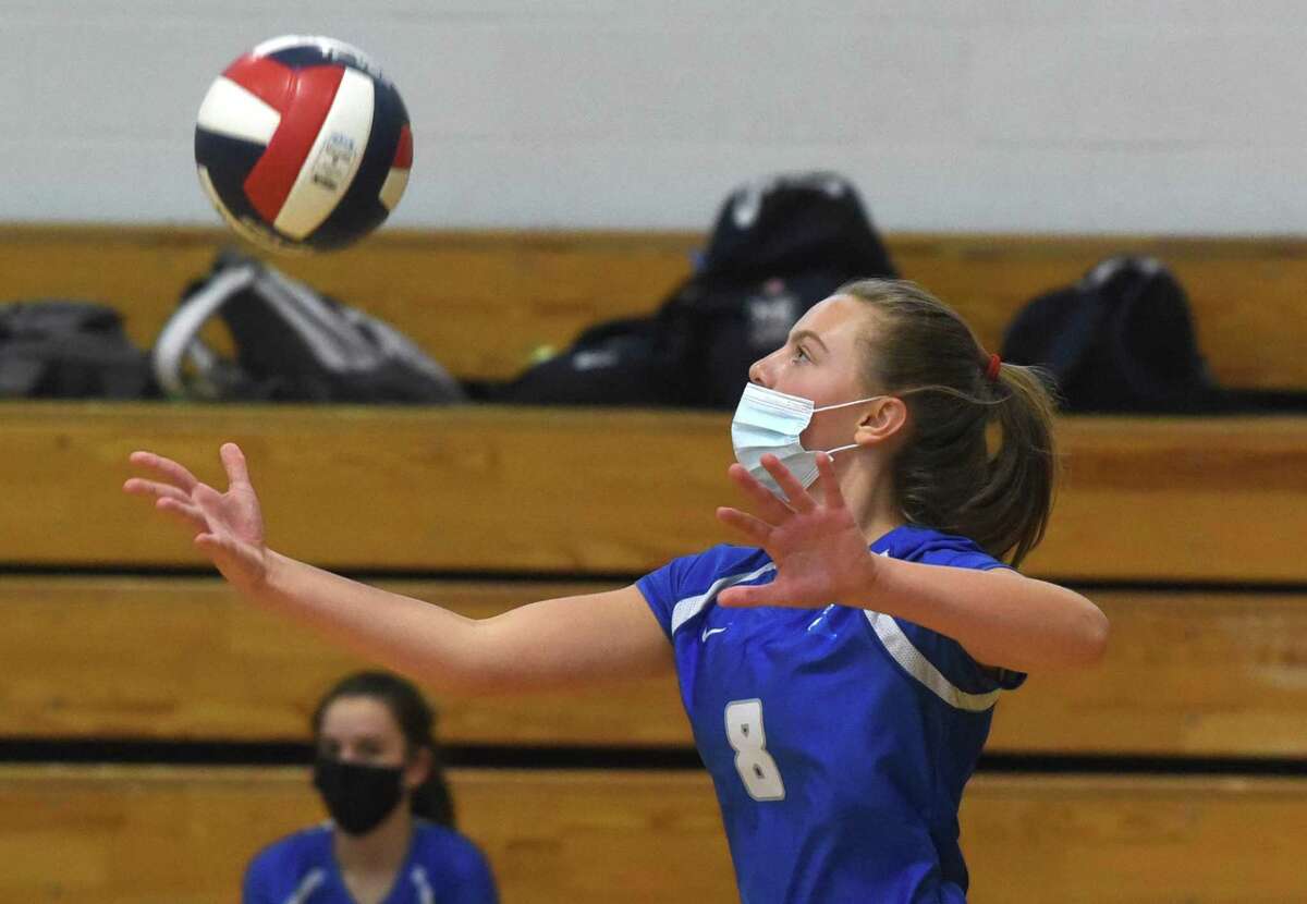 Darien's Aubrey Moore (8) serves the ball during a volleyball match against Newtown in Darien on Monday, Sept. 13, 2021.