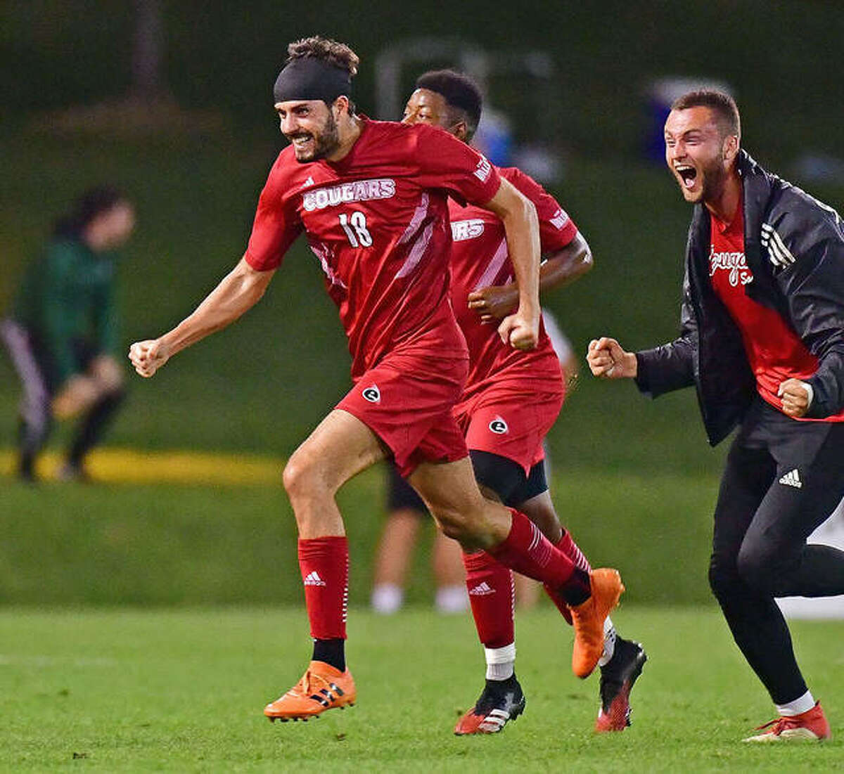 Pau Palacin of SIUE and teammates celebrate his second-half goal that pulled the cougars into a 1-1 tie with Saint Louis University in the 30th Bronze Boot soccer game Tuesday night at Hermann Stadium