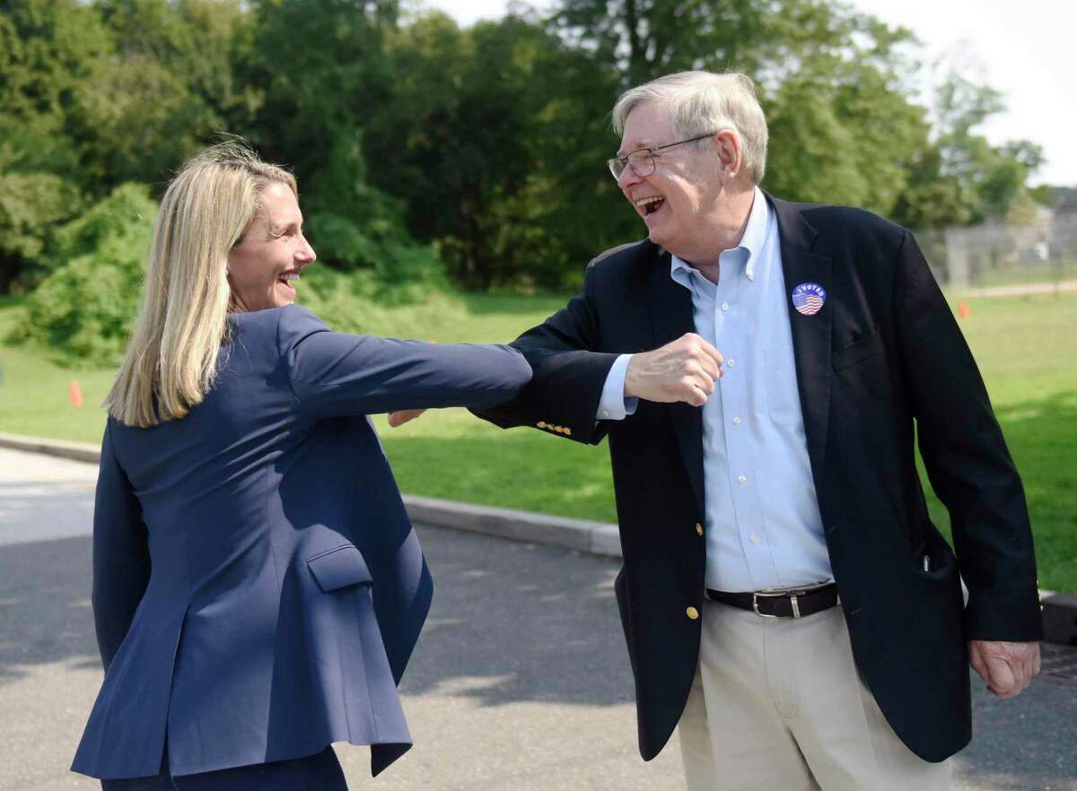 Mayoral candidate state Rep. Caroline Simmons and incumbent Mayor David Martin greet each other outside Dolan Middle School on Primary Election Day in Stamford last week.