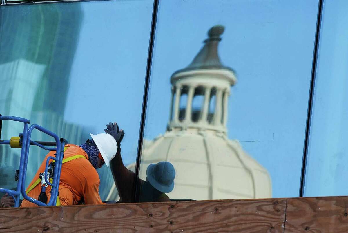 Construction crews put up windows on Harris County Courthouse in Houston on Thursday, Sept. 2, 2021.