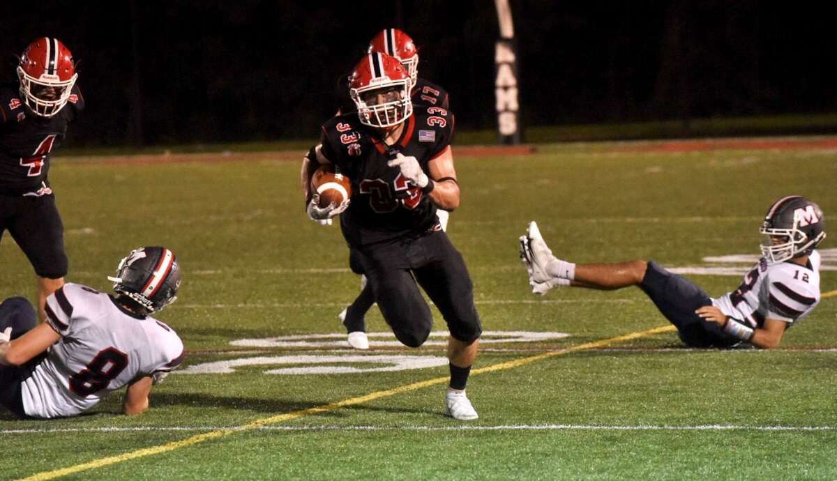 New Canaan’s Hunter Telesco (33) carries the ball during a football game against Brien McMahon on Friday, Sept. 17, 2021 at Dunning Stadium in New Canaan.