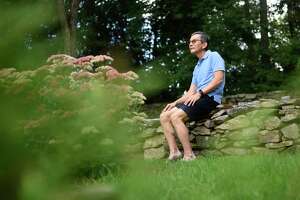 Robert Reiner, who identifies as Japanese American, poses outside his home in the backcountry of Greenwich, Conn. Tuesday, Aug. 31, 2021. Recently-released census shows major growth in Asian population in the Greenwich backcountry and midcountry, Riverside, North Mianus, and Old Greenwich.