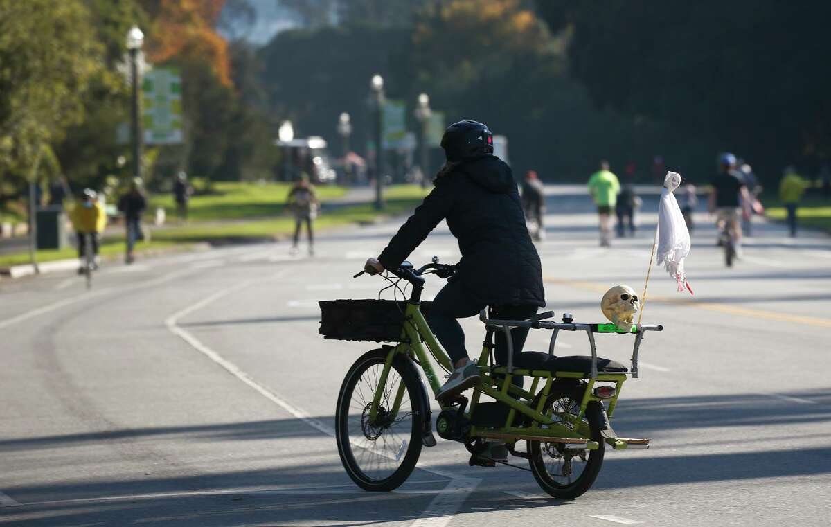 Bicyclists and walkers on JFK Drive in Golden Gate Park, which is currently closed to car traffic.