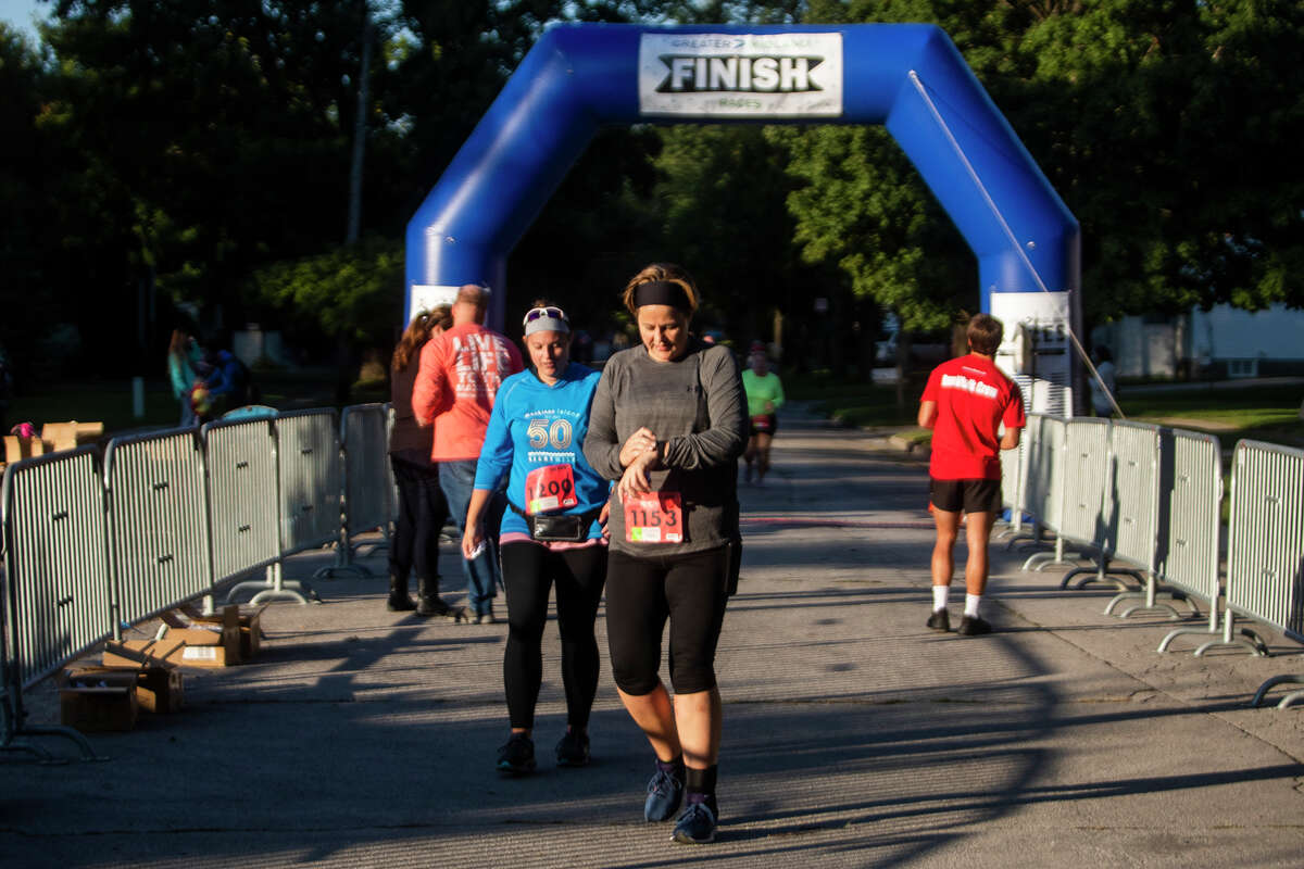 Runners and walkers approach the finish line while participating in the 2021 Dow RunWalk Saturday, Sept. 18, 2021 in Midland. (Katy Kildee/kkildee@mdn.net)