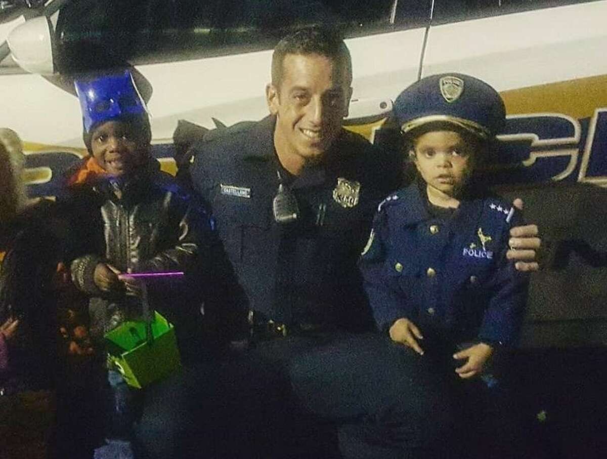 In this undated photo, New Haven Police Officer Joshua Castellano is seen working with children while in uniform.