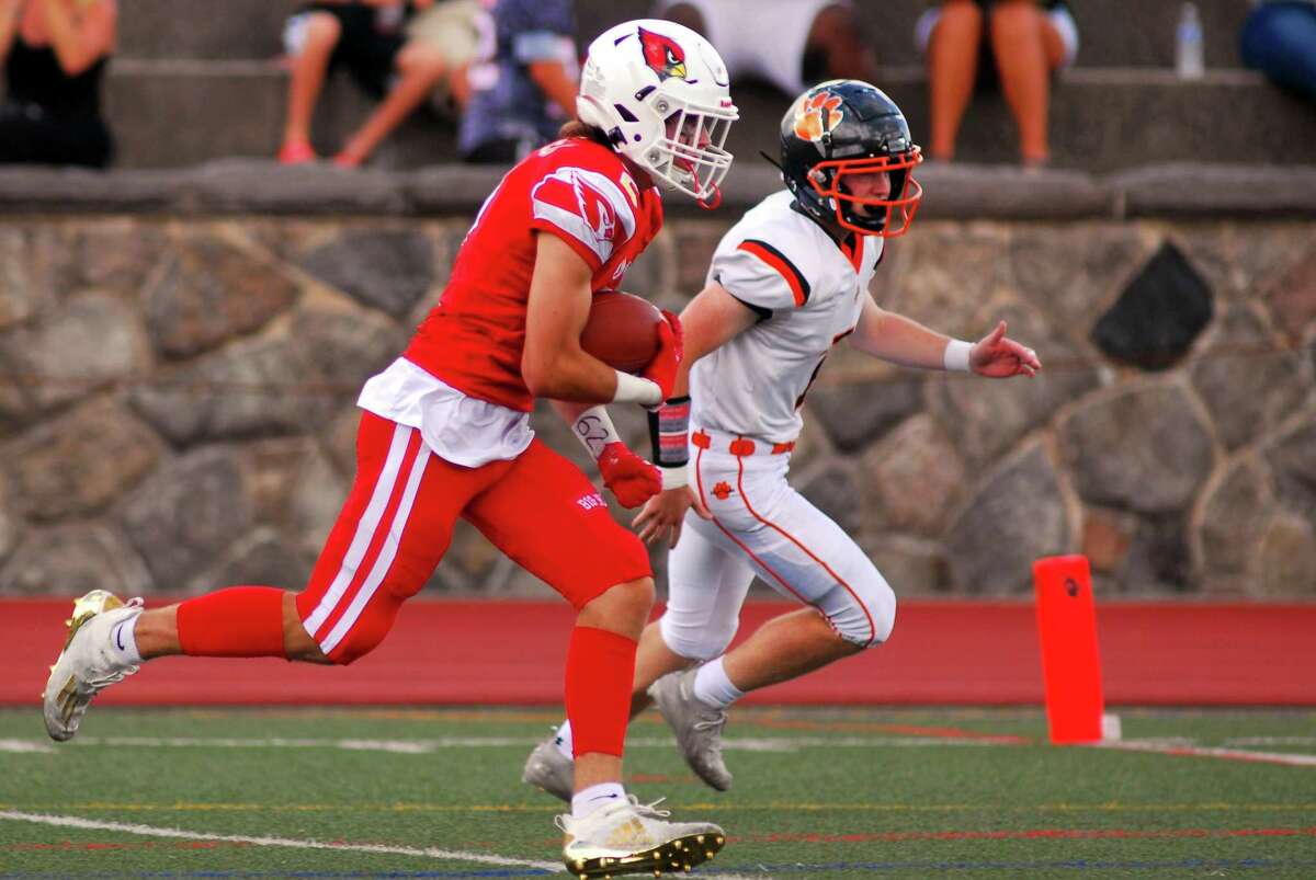 Greenwich’s James Wailgum (2) carries the ball into the endzone for a touchdown against Ridgefield on Saturday.