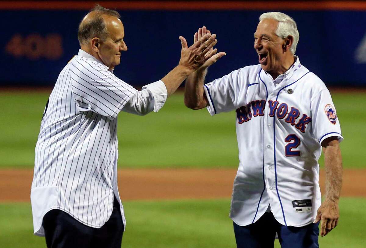 Former New York Yankees manager Joe Torre, left, and former New York Mets manager Bobby Valentine react after they threw out ceremonial first pitches before a baseball game Saturday, Sept. 11, 2021, in New York.