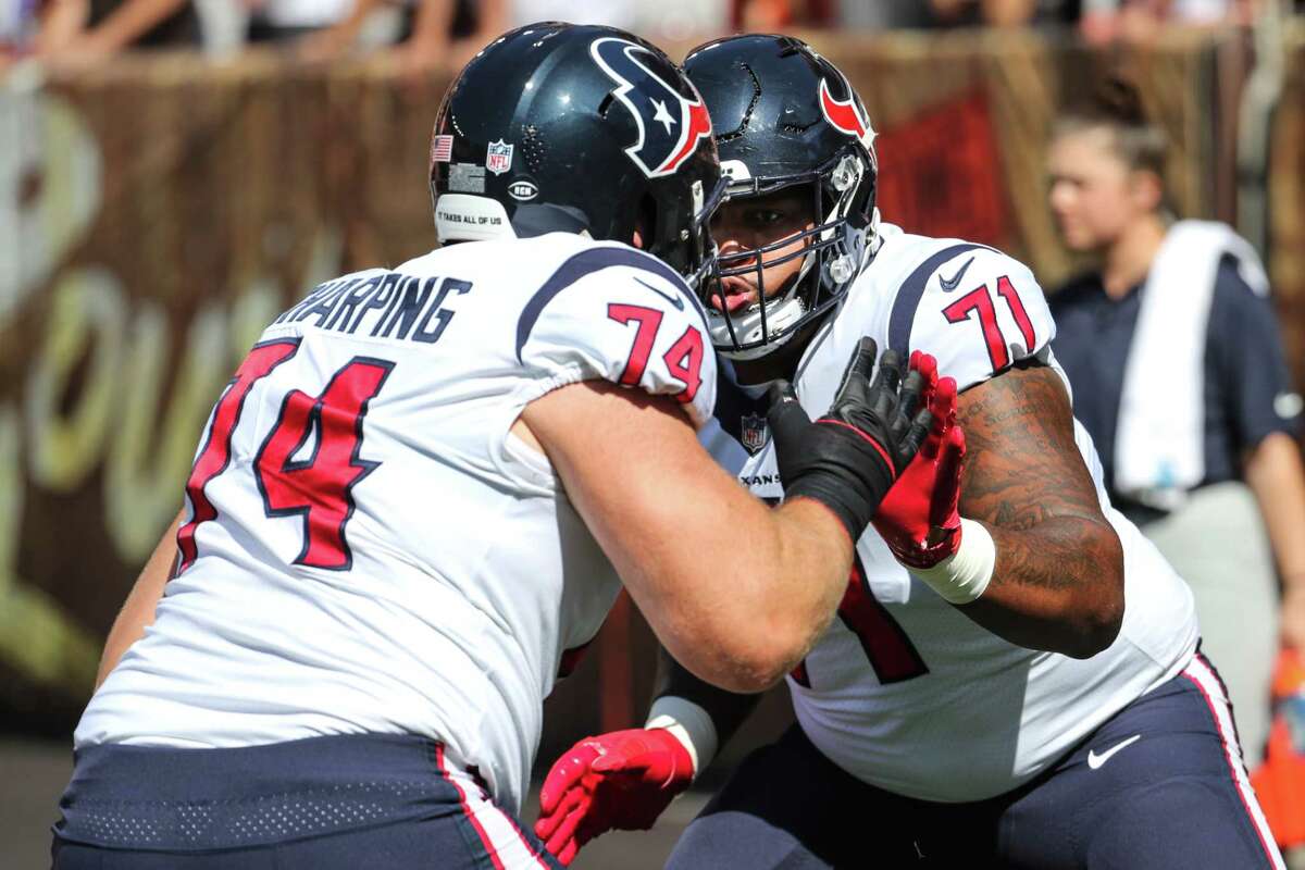 Houston Texans offensive linemen Max Scharping (74) and Tytus Howard (71) warm up before an NFL football game against the Cleveland Browns Sunday, Sept. 19, 2021, in Cleveland.