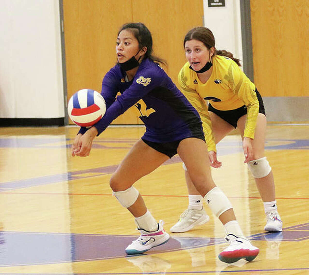 CM libero Ella Middleton (left) receives a serve in front of teammate Toni Reynolds in a match earlier this season. Middleton joined Lexi Biciocchi on the all-tourney team on Saturday while winning the Granite City Tournament.