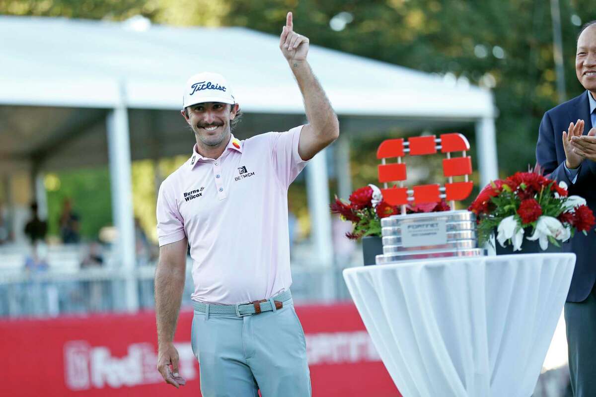 Max Homa celebrates next to the Fortinet Championship trophy after defeating Maverick McNealy by 1 stroke in final round at Silverado Resort in Napa, Calif., on Sunday, September 18th, 2021.