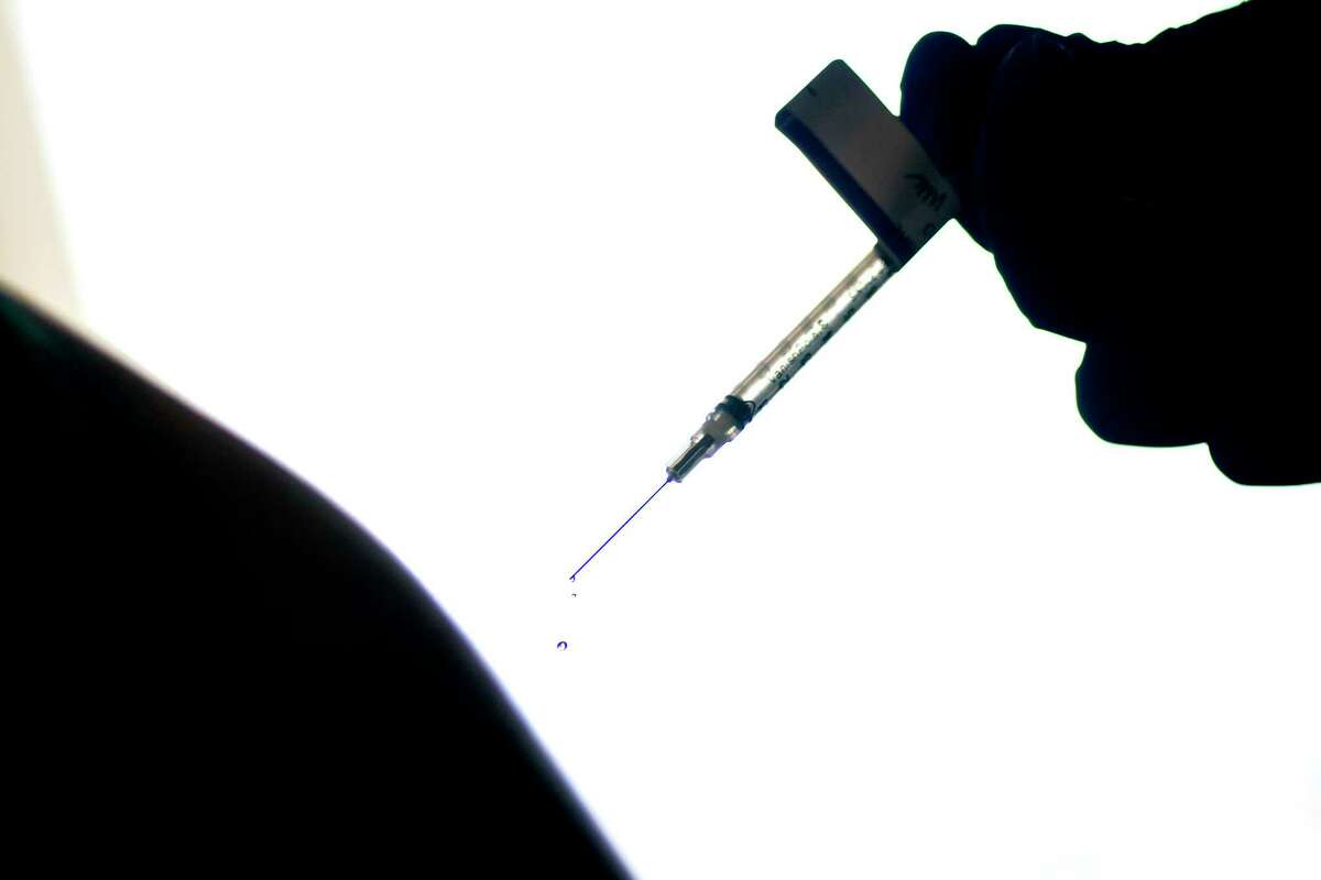 FILE - In this Dec. 15, 2020, file photo, a droplet falls from a syringe after a person was injected with the Pfizer COVID-19 vaccine at a hospital in Providence, R.I.