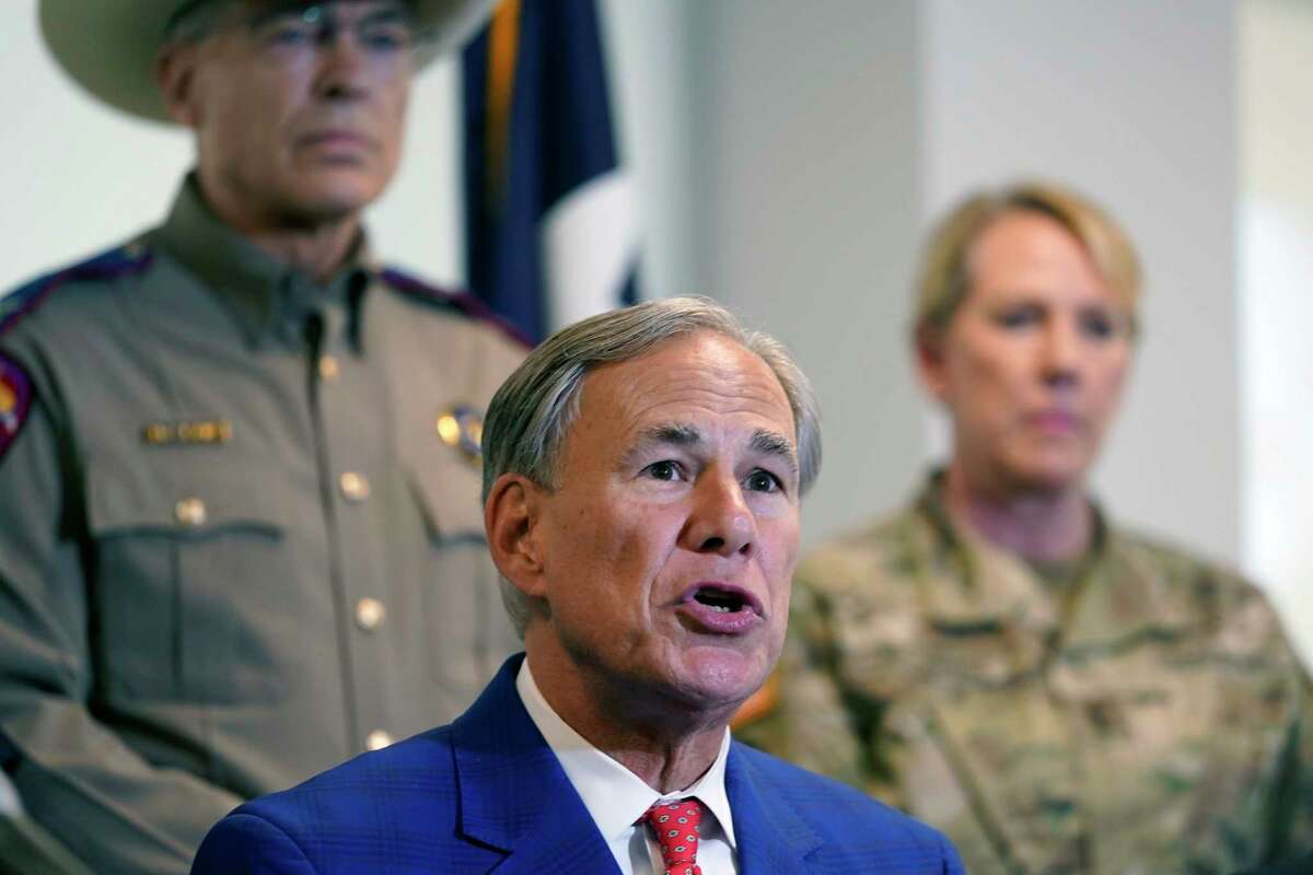 Texas Gov. Greg Abbott, front, speaks in front of Texas National Guard Director Maj. Gen. Tracy Norris, back right, and Director and Colonel of the Texas Department of Public Safety Steven McCraw after Abbott signed a bill providing additional funding for security at the U.S.-Mexico border, Friday, Sept. 17, 2021, in Fort Worth. (AP Photo/LM Otero)