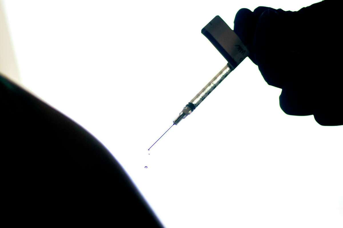 FILE - In this Dec. 15, 2020, file photo, a droplet falls from a syringe after a person was injected with the Pfizer COVID-19 vaccine at a hospital in Providence, R.I. (AP Photo/David Goldman, File)