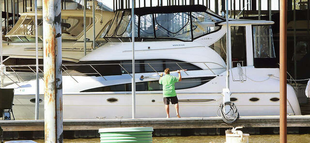 A man washes his boat in a slip this week at the Alton Marina where the boating season is winding down. Because Riverbend winter weather can greatly vary, harbormaster Greg Brown said to not winterize a boat in our region is not an option.