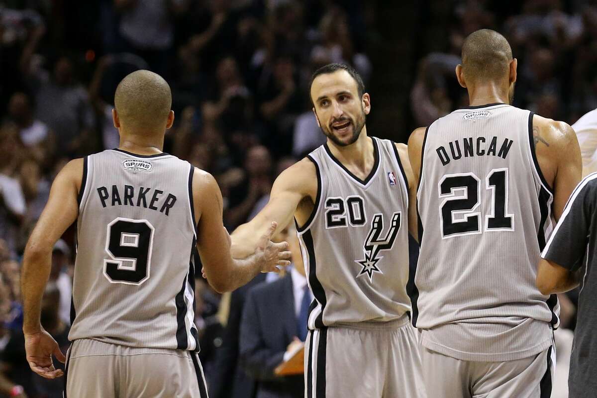 (L-R) Tony Parker #9, Manu Ginobili #20 and Tim Duncan #21 of the San Antonio Spurs celebrate a play as they walk to the bench during a timout in overtime against the Memphis Grizzlies during Game Two of the Western Conference Finals of the 2013 NBA Playoffs at AT&T Center on May 21, 2013 in San Antonio.