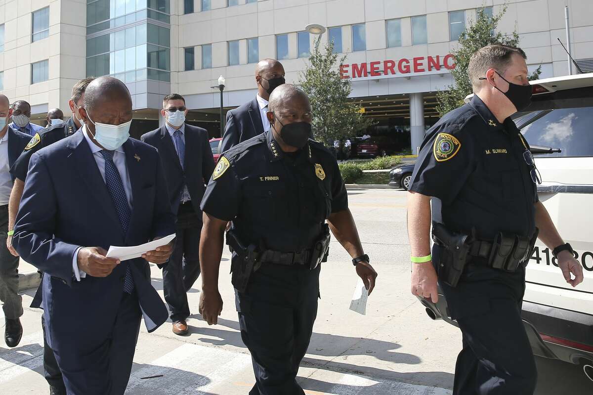 Houston Mayor Sylvester Turner, left to right, Houston Police Chief Troy Finner and Houston Police Executive Chief Matt Slinkard walk from the hospital to Hermann Park for a press conference on two police officers were shot dead while serving an arrest warrant in the 5300 block of Aeropark Drive on Monday, September 20, 2021, at Memorial Hermann Hospital in Houston.  One of the two officers was pronounced dead in hospital.  He has been identified as William Jeffrey, a veteran officer who joined the department in 1990. The other officer, who is said to be in stable condition, has been identified as Sgt.  Michel Vance.  He joined the department in 1997.
