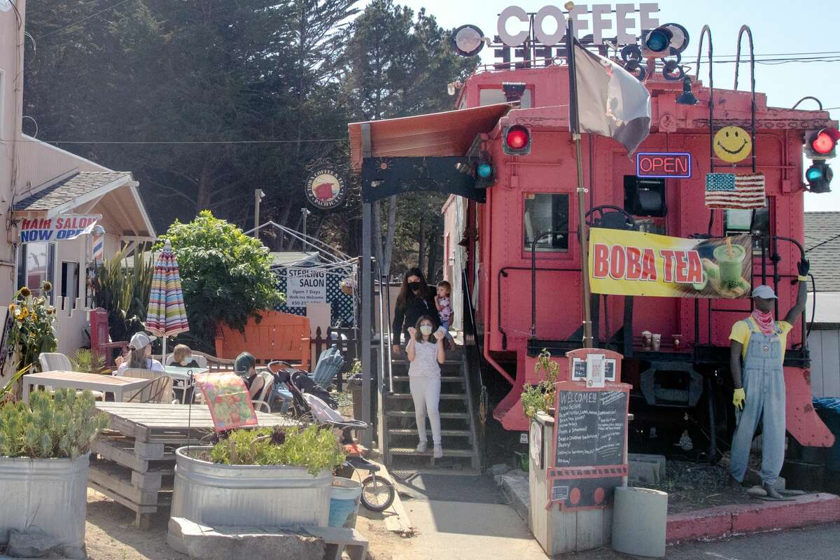 Customers walk down the steps of P-Town Coffee and Tea, a cafe in a train caboose, in Pacifica, Calif.