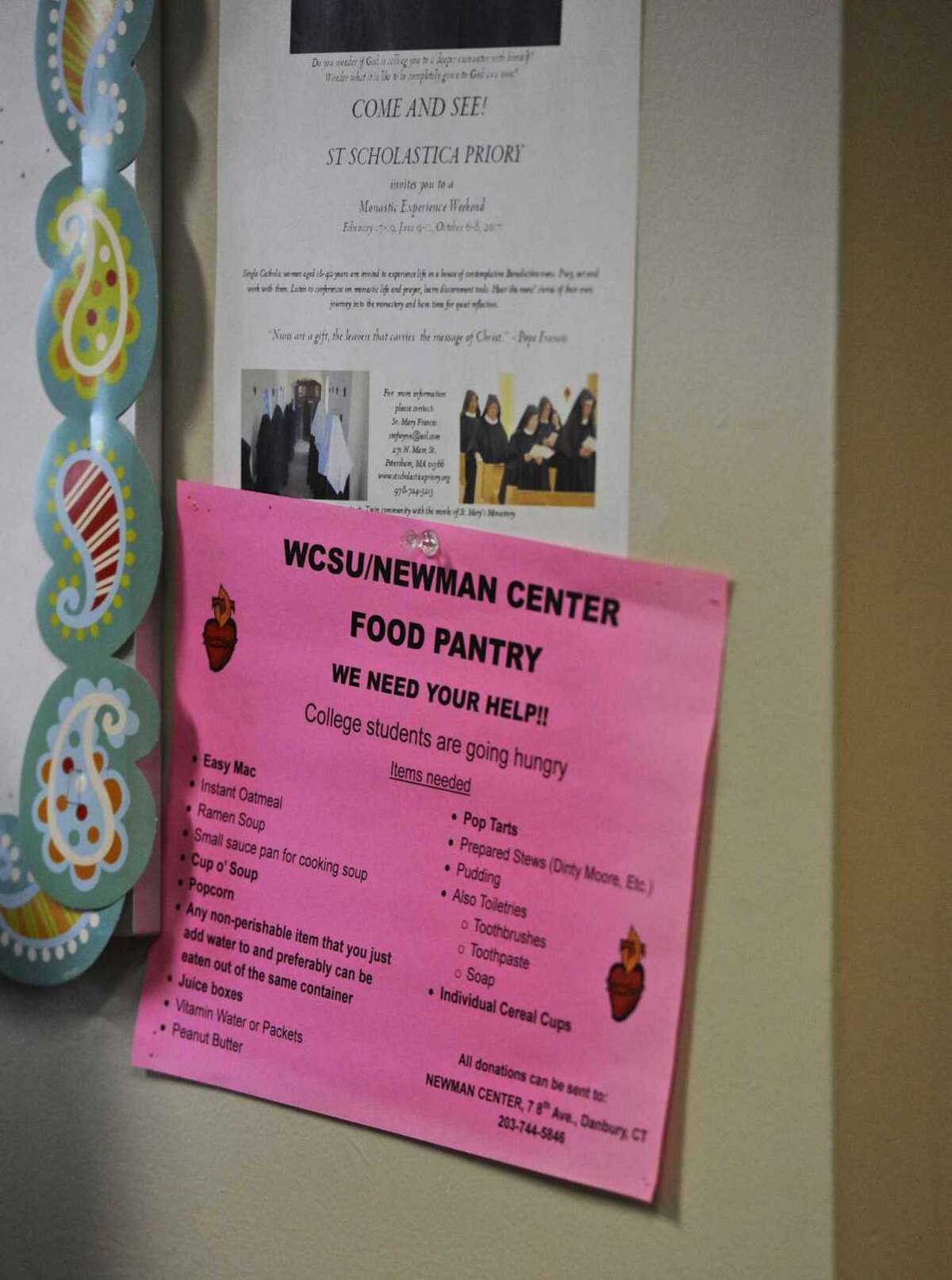 File photo. A sign for the Newman Center Food Pantry at Western Connecticut State University, asking for donations in Danbury, Conn.