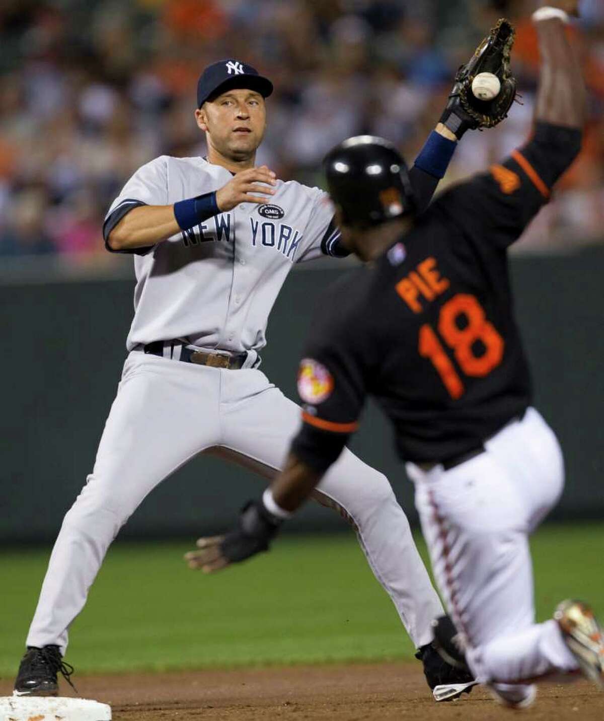 New York Yankees shortstop Derek Jeter forces out Baltimore Orioles' Felix Pie (18) at second base then drop the ball failing to get the runner at first during the second inning of a baseball game, Friday, Sept. 17, 2010, in Baltimore. (AP Photo/Rob Carr)