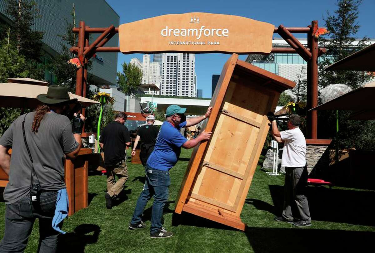 How Dreamforce 2022 impacts downtown SF traffic, travel and more. Daniel Barron (left) and Chris McGinnis, both trade show installer Freeman Co., move a counter as they work works setting up on Howard Street for Salesforce's Dreamforce 2021 conference at Moscone Center in San Francisco.